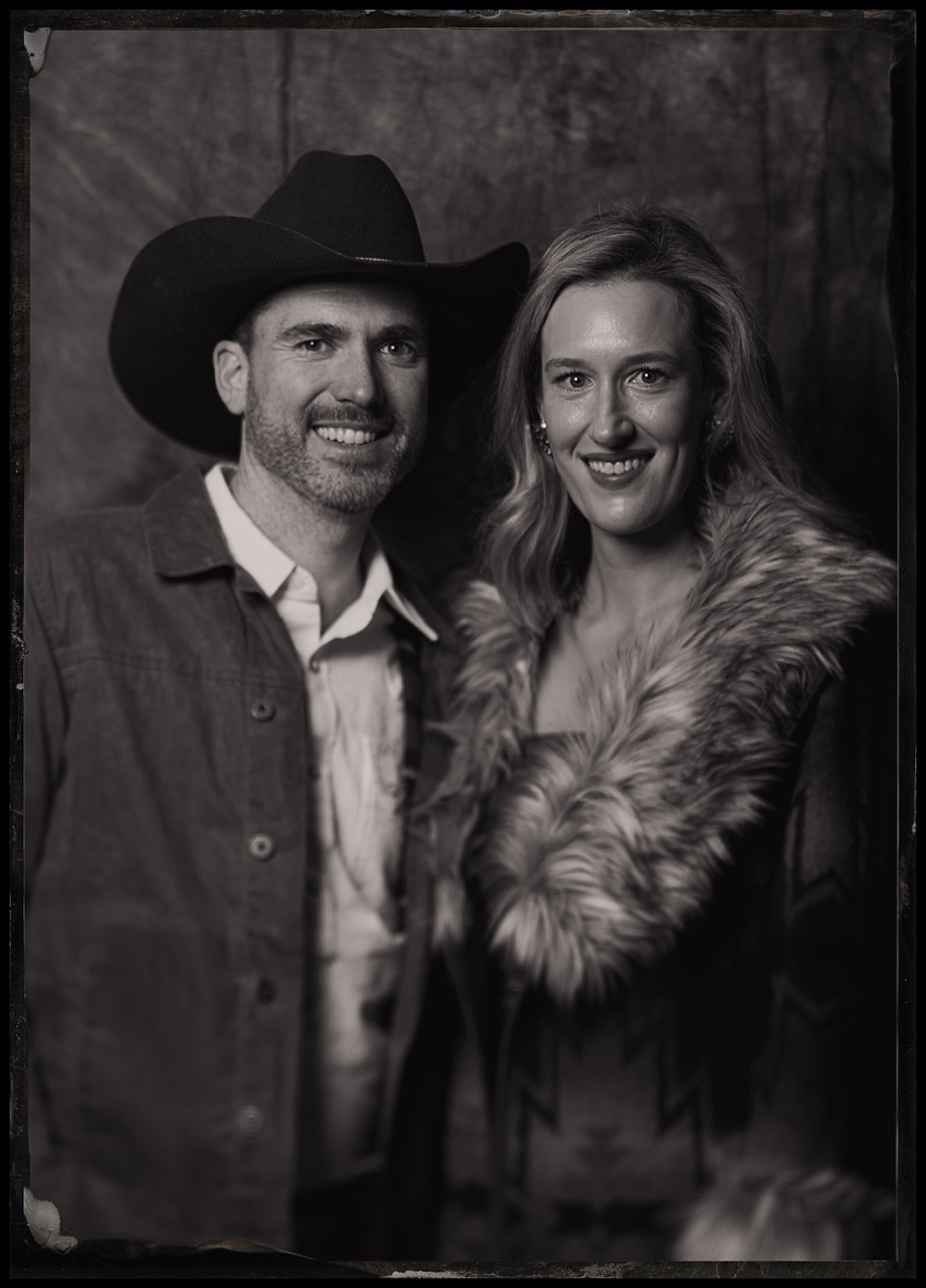 caribou club wedding welcome party tintypes in aspen portrait of couple wearing a furry coat